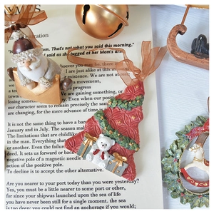 Detailed view of vintage resin Christmas tree and Santa ornaments with silk ribbons