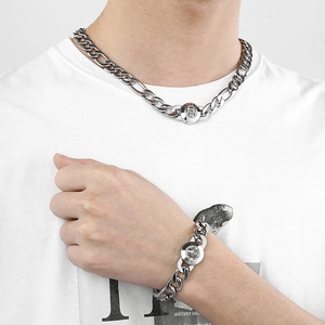 Detail of silver titanium NK chain set with round crystal buckle worn on a white shirt