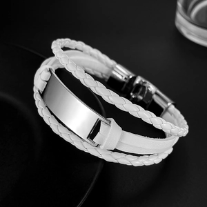 Detailed macro shot of white multi-layer braided leather bracelet with polished metal plate