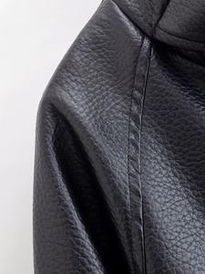 Detail of black faux leather jacket featuring premium lychee texture and double stitching