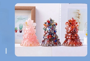 Three handmade crystal resin Christmas trees in pink, multi-color, and red with festive base