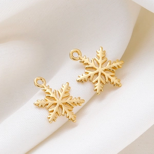 18K gold plated snowflake pendants on white silk background for DIY jewelry making