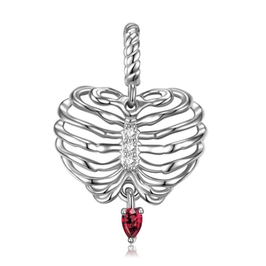 Detail of silver heart-ribcage pendant with three zircons and red heart gemstone