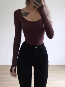 Slim fit burgundy long sleeve U-neck bodysuit paired with high waisted black trousers
