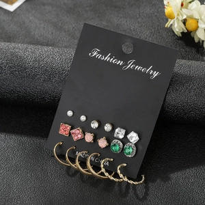 Close-up of 9 pairs earring set featuring pearls, crystals, and gold twisted hoops