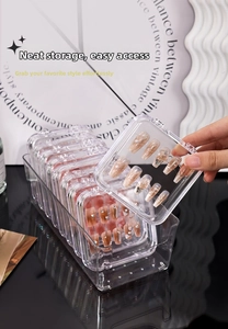 Detailed view of clear acrylic nail organizer box with individual small storage cases