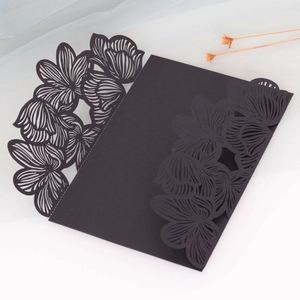 Detailed laser-cut floral patterns on elegant black wedding invitation envelope
