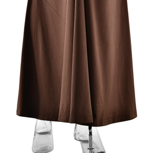 Detail shot of brown fishtail dress hem showing smooth drape and knitted fabric texture