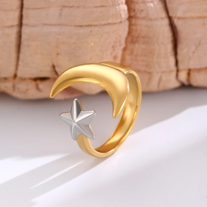 Detail of star and moon open ring with gold and silver two-tone metallic finish