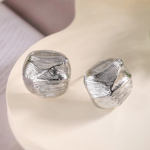 Minimalist silver geometric stud earrings with brushed texture and modern design