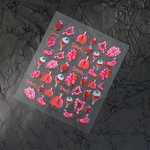 3D embossed Halloween nail stickers with anatomical heart eyeball designs on black background