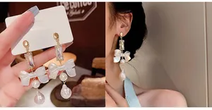 Detail of bowknot pearl earrings with S925 silver needles and rectangular zircon inlay