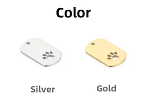 Close-up of gold and silver dog tags featuring a hollowed paw print design on white background