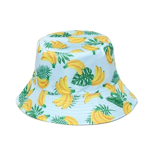 Detailed view of light blue bucket hat with banana and tropical leaf print pattern