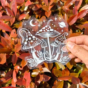 Detail of static suncatcher sticker with white mushroom and moon line art on glass