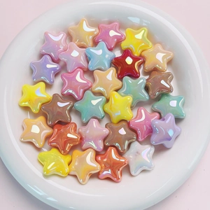 Colorful UV plated star beads in a white dish for DIY jewelry and phone chain making