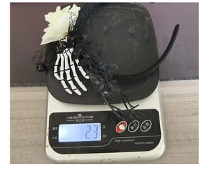 Lightweight Halloween gothic headband with white flowers and skull hand weighing 23 grams