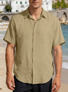 Detail of khaki men's short sleeve shirt showing cotton linen texture on beach background