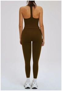 Detail of olive green crisscross sports bra and high-waisted leggings set from behind