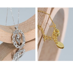 Detail of S925 sterling silver tulip pendant with gold-plated clasp and hallmark