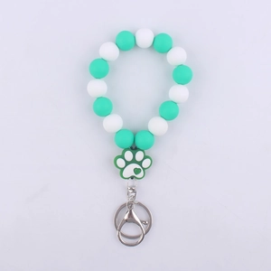 Silicone beaded keychain with white and teal beads featuring a cute paw print charm