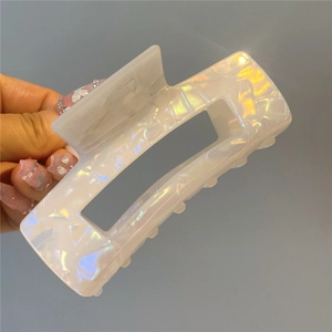 Detailed view of a large white acetate square hair claw with pearlescent shimmering texture