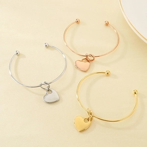 Three minimalist heart knot open bangles in gold, silver and rose gold finishes