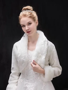 Detail of white bridal faux fur shawl with plush collar and cuffs for winter weddings