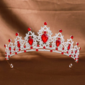 Detailed close-up of a silver bridal crown with red gemstones and sparkling rhinestones