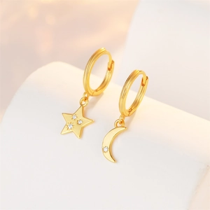 Detail of gold S925 sterling silver star and moon earrings with cubic zirconia stones