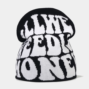 Detail of Y2K knit beanie with I LIKE NEED MONEY jacquard lettering in black and white