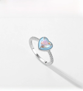 Macro detail of S925 sterling silver ring featuring a heart-shaped opal and blue coating