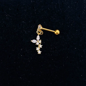 Macro shot of gold butterfly stud earring with clear zircon and screw ball back
