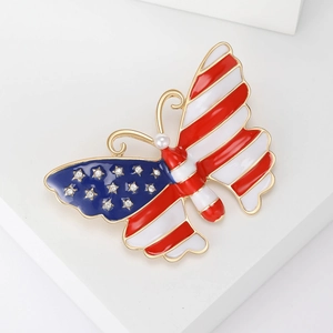 Luxurious American flag butterfly brooch with red stripes, blue stars and a pearl