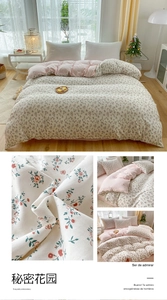 Close-up of red floral embroidery on cream duvet cover with soft pink inner lining