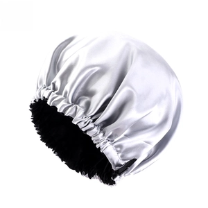 Detail of silver satin sleep cap with black lining and elastic ruffled trim design
