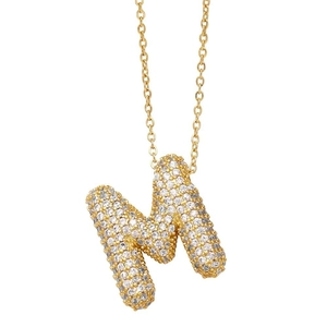 Detail of 3D gold balloon letter M pendant with shimmering crystals on a fine chain