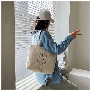 Detailed view of cream corduroy tote bag featuring a cute rabbit embroidery for women