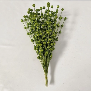 Close-up of artificial green glitter berry stem for Christmas holiday decoration