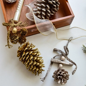 Rustic Christmas pine cone ornaments in gold, silver and natural wood with hemp rope