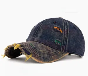 Close-up of distressed denim baseball cap with colorful stitching and vintage ripped details