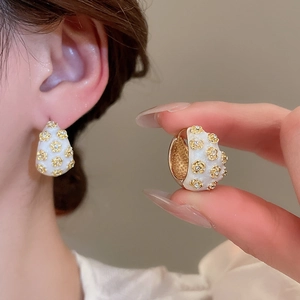 Detail view and model shot of vintage enamel flower hoop earrings with small diamonds