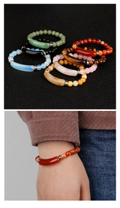 Macro shot of assorted natural stone beaded bracelets with curved metallic bar detail