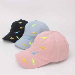 Detailed view of colorful dinosaur embroidery on black blue and pink cotton baseball caps
