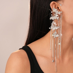 Detail of silver butterfly ear cuff with sparkling rhinestone tassel chains on model
