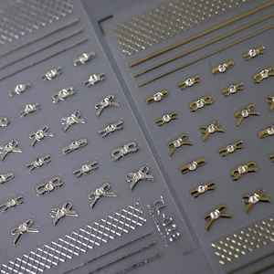 5D stereoscopic metal bow nail stickers in gold and silver with rhinestones
