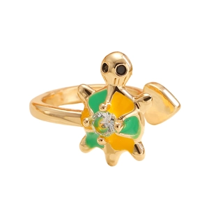 Detailed close-up of a golden turtle ring featuring green enamel and a sparkling crystal