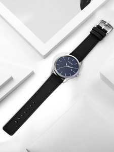 Minimalist quartz watch with silver stainless steel case and dark blue date dial