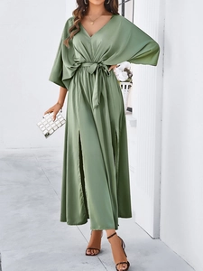 Detailed view of the green V-neck long dress with a waist tie and side split design
