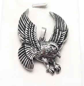 Detailed macro view of vintage stainless steel eagle wing pendant with engraved texture